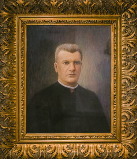 Zdjęcie przedstawia olejny portret w złotej ramie, na portrecie jest duchowny, w sutannie. Mężczyna ma krótkie, siwe włosy. To ks. parłat Ignacy Lasocki.